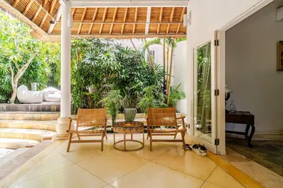 a living room with a table and chairs at Villa Bliss Umalas in Kerobokan