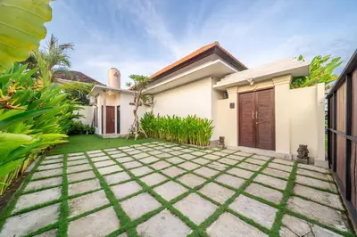 a house with a garden and a driveway at New Villa in the best area in Kuta