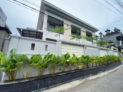 a row of potted plants on the side of a building at Semilang House in Ngurah Rai International Airport