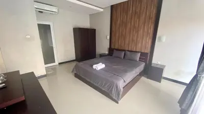 a bedroom with a bed with a towel on it at Semilang House in Ngurah Rai International Airport