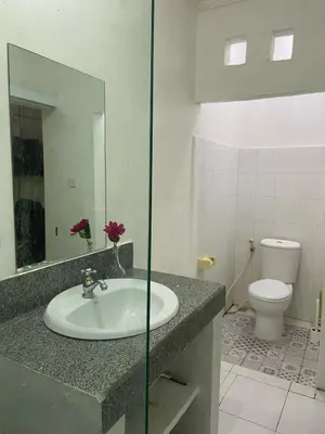 a bathroom with a sink and a toilet at Cozy room Kuta - 1 minutes to the beach by Micky Studio in Legian