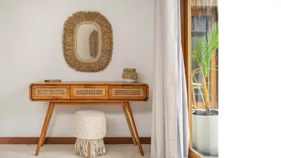 a dressing table with a mirror on a wall at 2min Beach, Atlas, Finns Canggu in Canggu