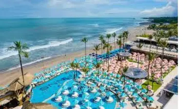 an aerial view of a beach with umbrellas and chairs at 2min Beach, Atlas, Finns Canggu in Canggu