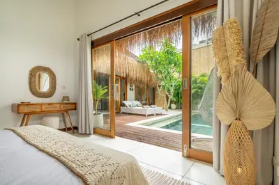 a bedroom with a bed and a view of a pool at 2min Beach, Atlas, Finns Canggu in Canggu