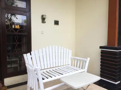 a white bench sitting in a room with a door at Simple apartment 3 in Seminyak