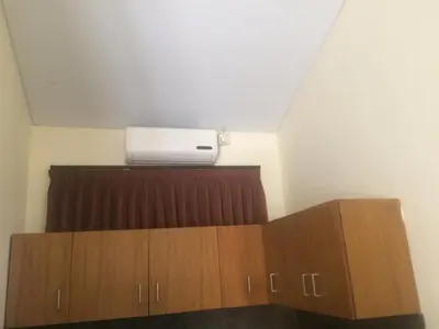 a room with a air conditioner on the ceiling at Simple apartment 3 in Seminyak
