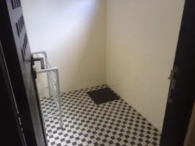 a bathroom with a black and white checkered floor at Simple apartment 3 in Seminyak