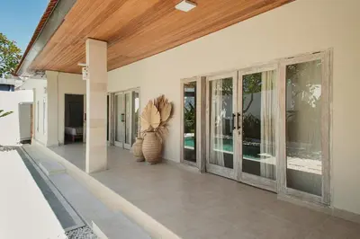 a porch of a house with a vase with a plant at 3 Bathroom Bali villa in Kerobokan