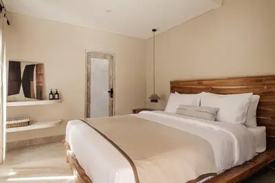 a bedroom with a large bed and a mirror at 3 Bathroom Bali villa in Kerobokan