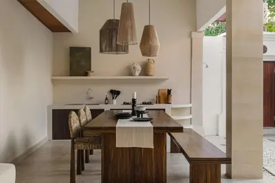 a kitchen with a wooden table and chairs at 3 Bathroom Bali villa in Kerobokan