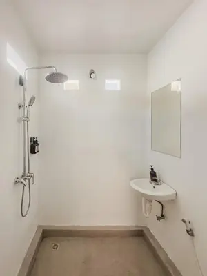 a bathroom with a shower and a sink at 3 Bathroom Bali villa in Kerobokan