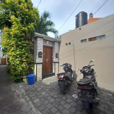 two motorcycles parked in front of a building at Ben & B villa in Kerobokan