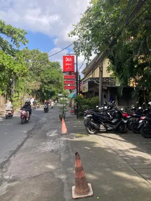 a street with motorcycles parked on the side of the road at Ben & B villa in Kerobokan
