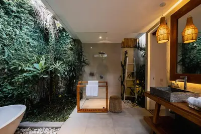 a bathroom with a bath tub and a sink at Villa Pacha Seminyak in Seminyak