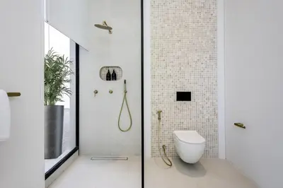 a bathroom with a toilet and a glass door at Brand New Luxury5 Stars Designer By Villa Amare Villa 3 in Kerobokan