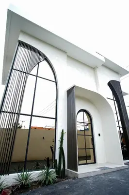 a white building with large windows and a door at Brand New Luxury5 Stars Designer By Villa Amare Villa 3 in Kerobokan