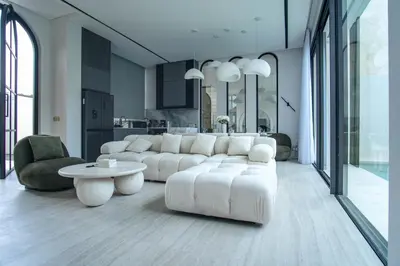 a living room with a white couch and a table at Brand New Luxury5 Stars Designer By Villa Amare Villa 3 in Kerobokan