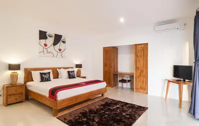 a bedroom with a bed and a tv in it at 3BR Villa3 Oberoi Seminyak,18Min walk to the beach in Seminyak