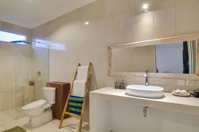 a bathroom with a sink and a toilet and a mirror at 3BR Villa3 Oberoi Seminyak,18Min walk to the beach in Seminyak