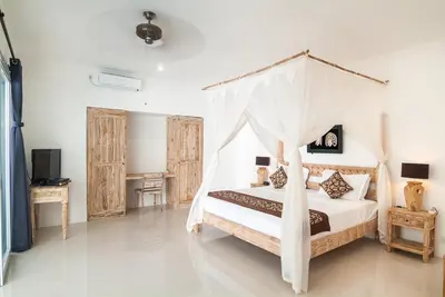 a bedroom with a bed with a canopy at 3BR Villa4 Oberoi Seminyak,18m walk to the beach in Seminyak