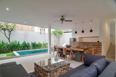 a living room with a table and a dining room at 3BR Villa4 Oberoi Seminyak,18m walk to the beach in Seminyak