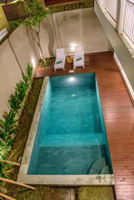 an overhead view of a swimming pool with two white chairs at 3BR Villa4 Oberoi Seminyak,18m walk to the beach in Seminyak