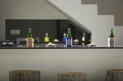 three bottles of beer sitting on top of a counter at 2BR Villa Central Seminyak,50 m walk to the beach in Seminyak
