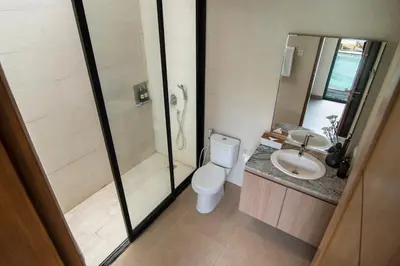 a bathroom with a shower and a toilet and a sink at LaBumbak 01 - 2BR Villa Escape in Umalas with Private Pool in Canggu