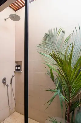 a shower stall with a plant in a bathroom at LaBumbak 01 - 2BR Villa Escape in Umalas with Private Pool in Canggu