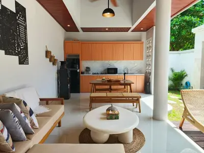 a living room with a couch and a table at Rumah Kodel4 by iBali Management in Seminyak