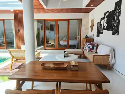 a living room with a table and a couch at Rumah Kodel4 by iBali Management in Seminyak