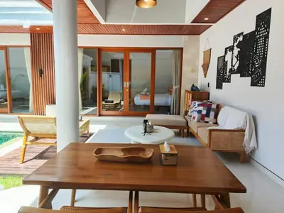 a living room with a table and a couch at Rumah Kodel4 by iBali Management in Seminyak