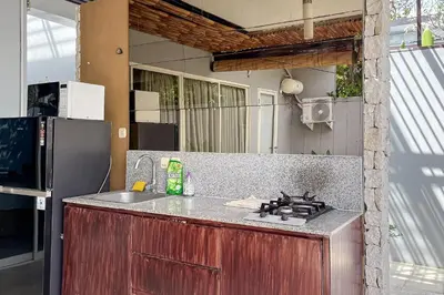 a kitchen with a counter with a sink and a stove at Garden Leaf Villa - 2 Bedroom Pool Villa with Minimum Stay 2 Nights in Nusa Dua