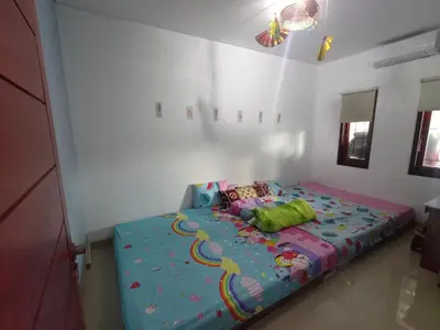 a bedroom with a bed with a colorful comforter at Designer Alex Villa Jimbaran Bali in Jimbaran