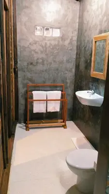 a bathroom with a sink and a toilet at Queen's Cabin in Kerobokan
