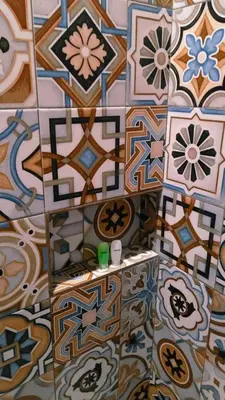 a bathroom with colorful tiles on the floor at Queen's Cabin in Kerobokan