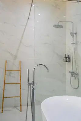 a bathroom with a shower and a tub and a sink at Villa Shinta by JB Villas in Seminyak