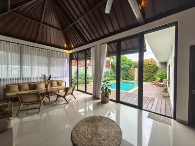 a living room with a couch and a table at Villa Veyla Seminyak 10 mins walk to beach in Seminyak