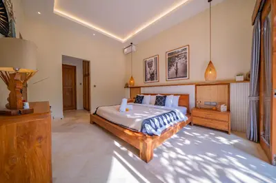 a bedroom with a large bed in a room at Luxury Balinese Oasis with private pool - 2 BR in Kerobokan