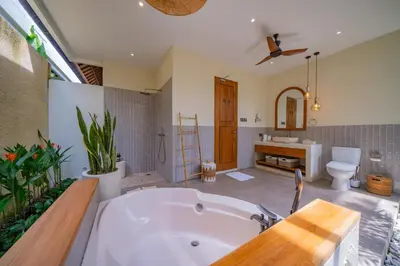 a large bathroom with a tub and a toilet at Luxury Balinese Oasis with private pool - 2 BR in Kerobokan