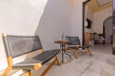 a living room with two chairs and a table at Villa Fénix Brand New 1BR Villa in Umalas, Bali in Kerobokan