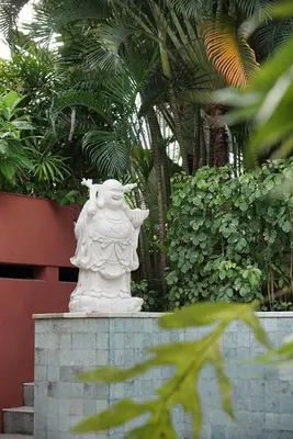 a white statue sitting on top of a wall at Walk, Best of Berawa, 5bd villa, 2min from Finns in Canggu