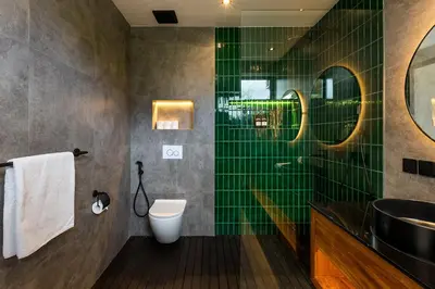 a bathroom with green tiles and a shower at Walk, Best of Berawa, 5bd villa, 2min from Finns in Canggu