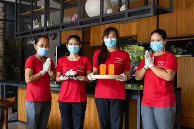 four women in red shirts holding a box of food at Walk, Best of Berawa, 5bd villa, 2min from Finns in Canggu