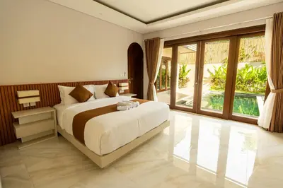a bedroom with a large bed and large windows at NEW! 3BR HnRR Villa Near Seminyak in Kerobokan