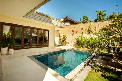 a swimming pool in the backyard of a house at NEW! 3BR HnRR Villa Near Seminyak in Kerobokan