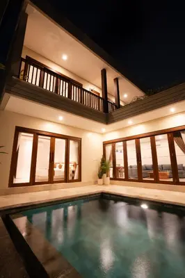 a swimming pool in a house at night at NEW! 3BR HnRR Villa Near Seminyak in Kerobokan