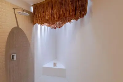 a bathroom with a shower with a white shower curtain at Villa Cocodrilos 1 by Pertama Management in Seminyak