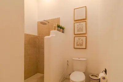 a bathroom with a toilet and a shower at Villa Cocodrilos 1 by Pertama Management in Seminyak