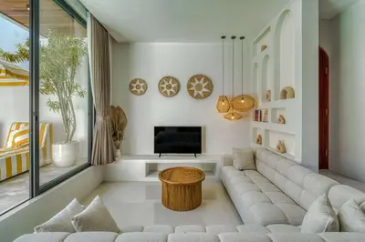 a living room with a couch and a tv at The Coral Villa 3 BR Brand New Villa in Umalas in Kerobokan